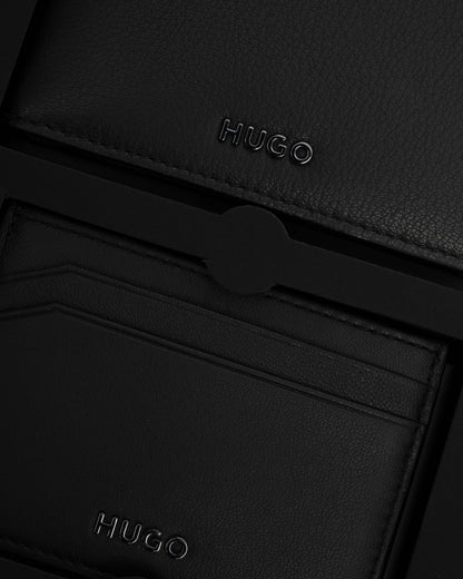 Close-up of a black leather wallet with 'HUGO' branding.