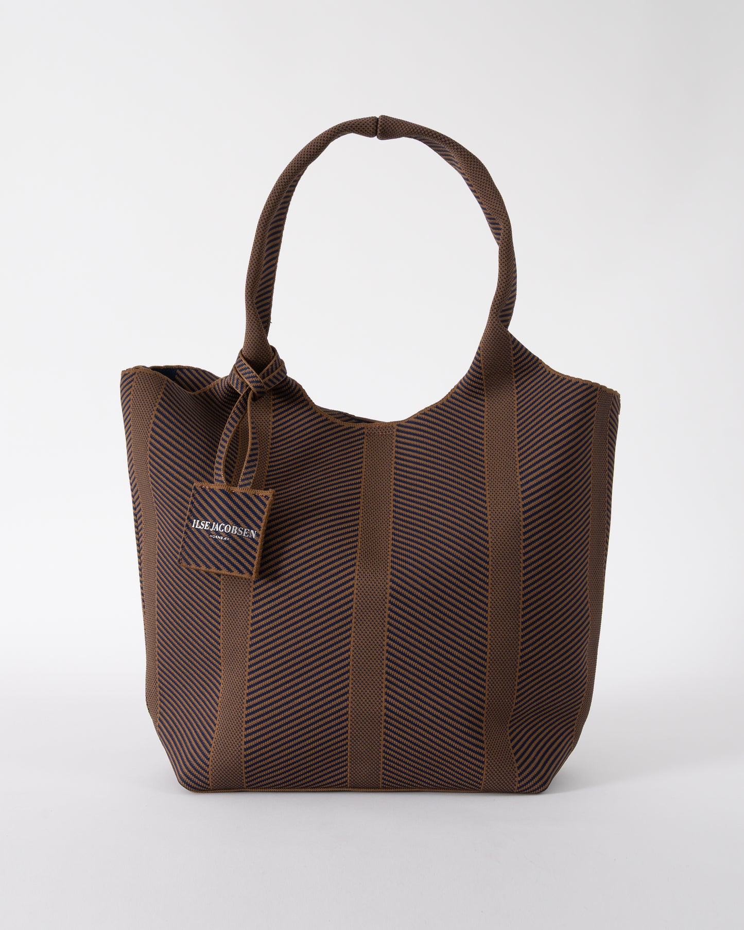 studio shot of Ilse Jacobsen Knitty Womens Knitted Bag in Dark Indigo and Buckthorn Brown