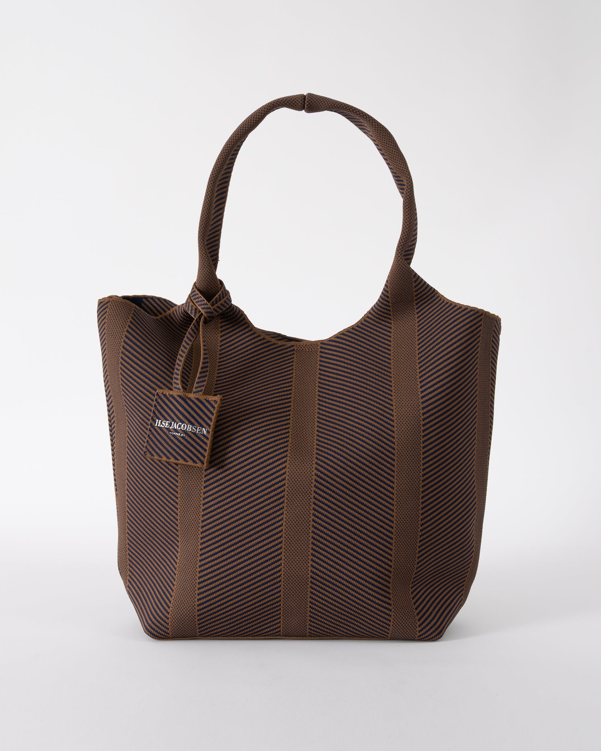 studio shot of Ilse Jacobsen Knitty Womens Knitted Bag in Dark Indigo and Buckthorn Brown