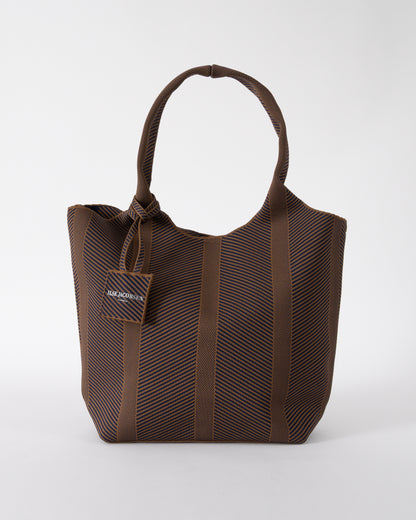 studio shot of Ilse Jacobsen Knitty Womens Knitted Bag in Dark Indigo and Buckthorn Brown