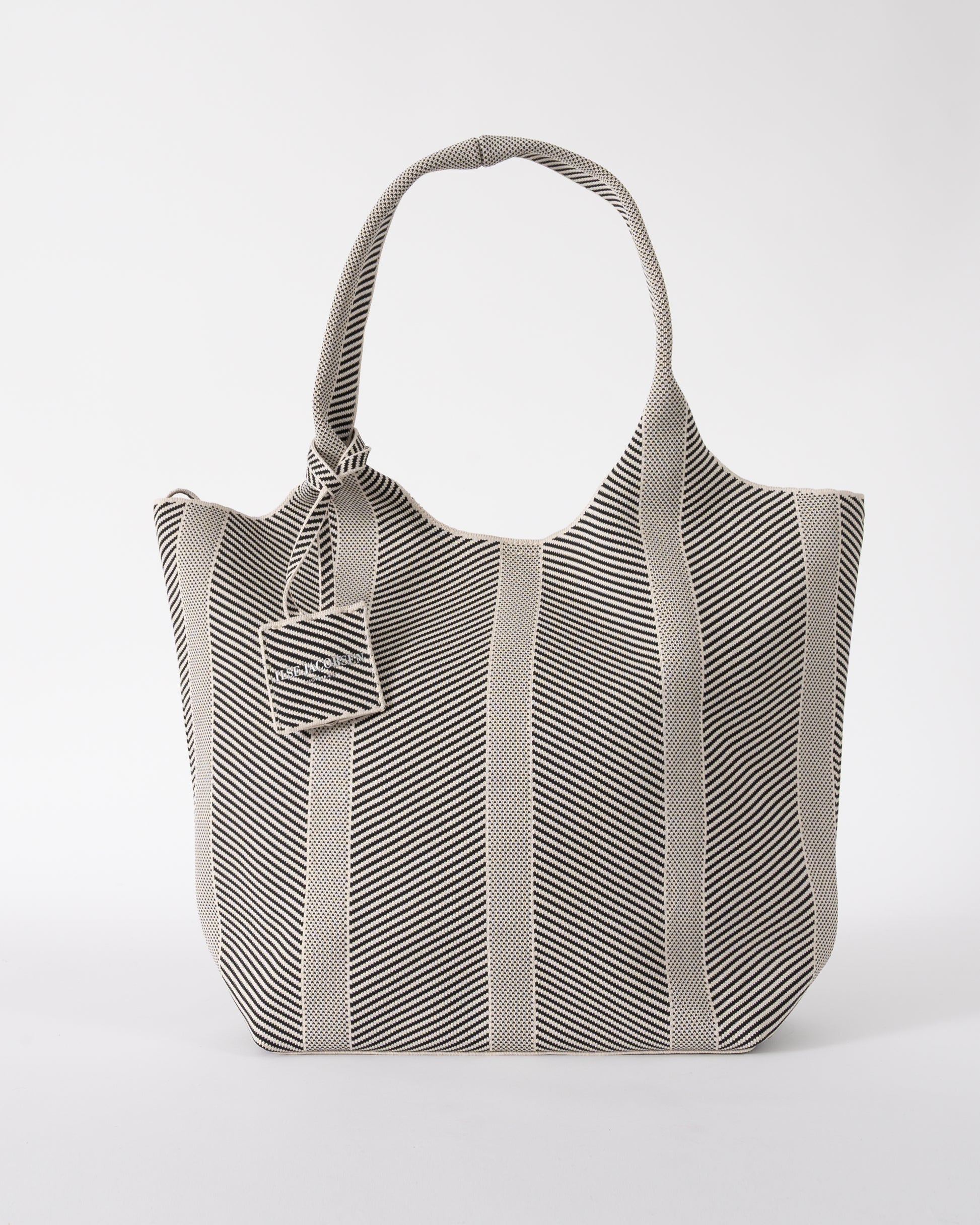 Studio shot of Ilse Jacobsen Knitty Womens Knitted Bag in Milk Creme and  Black