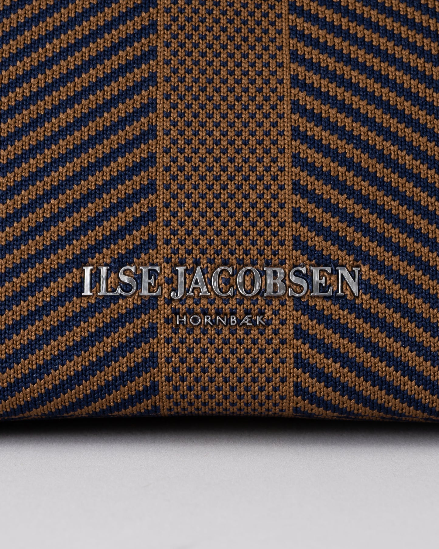 logo detail of Ilse Jacobsen Knitty Womens Knitted Makeup Bag in Dark Indigo and Buckthorn Brown