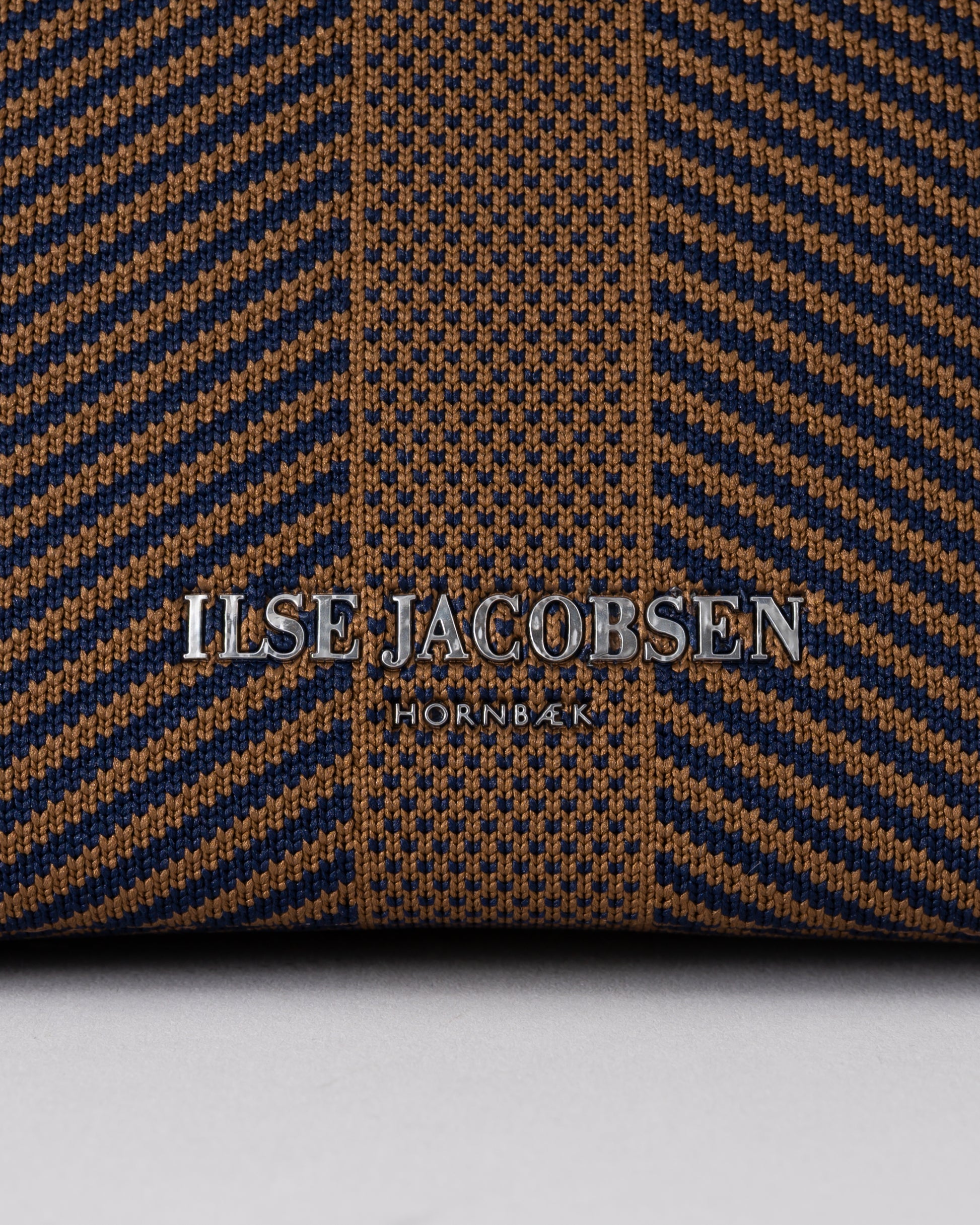 logo detail of Ilse Jacobsen Knitty Womens Knitted Makeup Bag in Dark Indigo and Buckthorn Brown