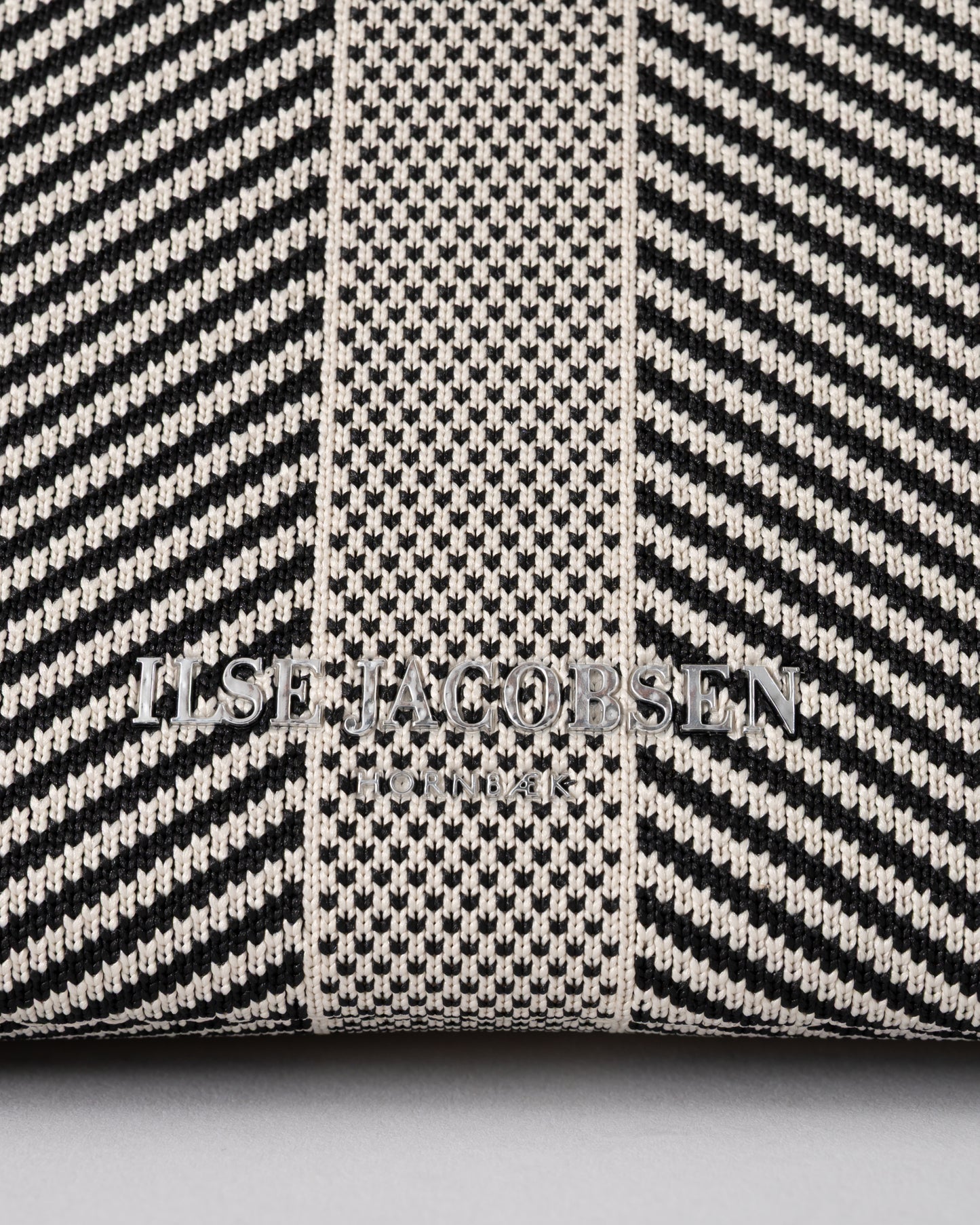 logo detail of Ilse Jacobsen Knitty Womens Knitted Makeup Bag in Milk Creme and Black