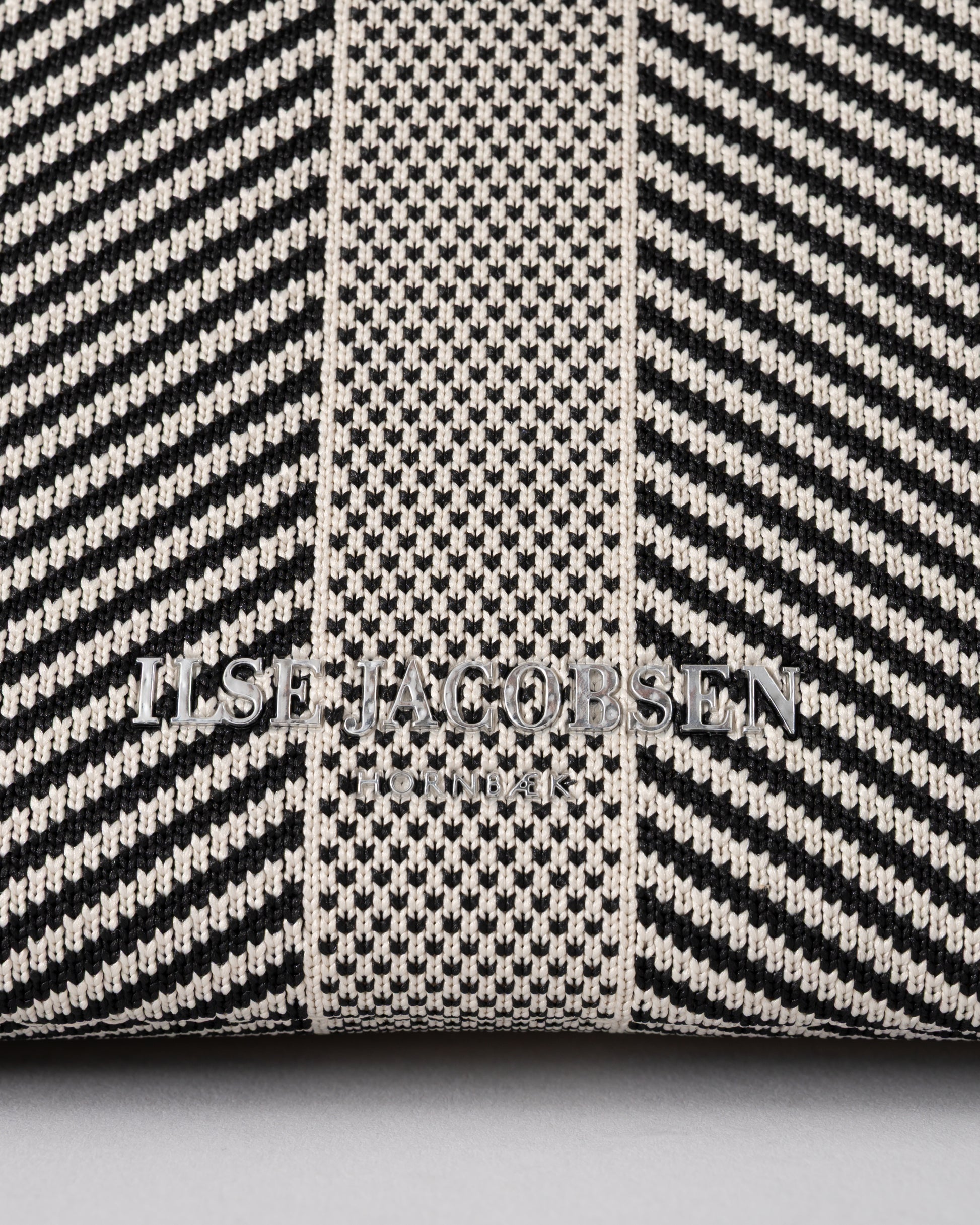 logo detail of Ilse Jacobsen Knitty Womens Knitted Makeup Bag in Milk Creme and Black
