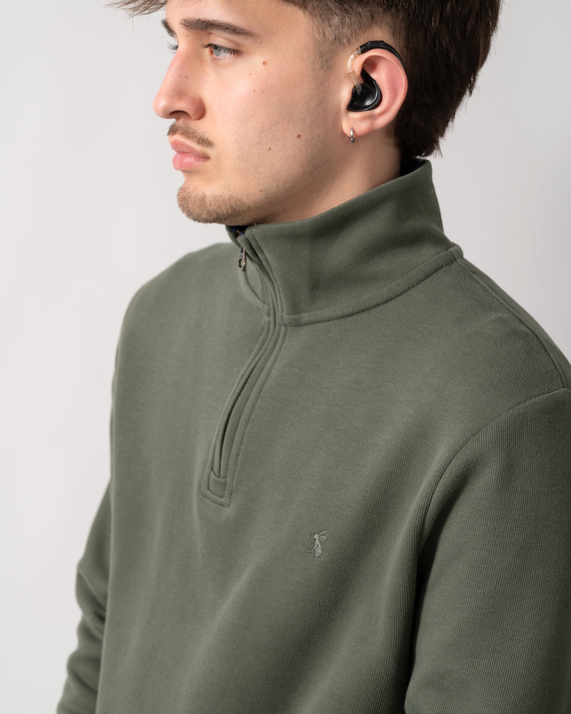 close up shot of a model wearing a Joules Alistair Mens 1/4 Zip Sweatshirt in Khaki Green