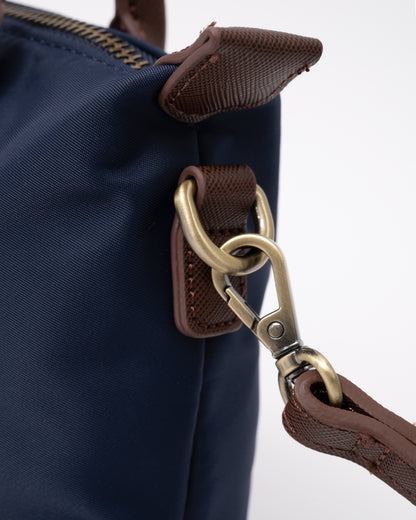 strap attachment detail of a Joules Edie Womens Mini Crossbody Handbag in Navy