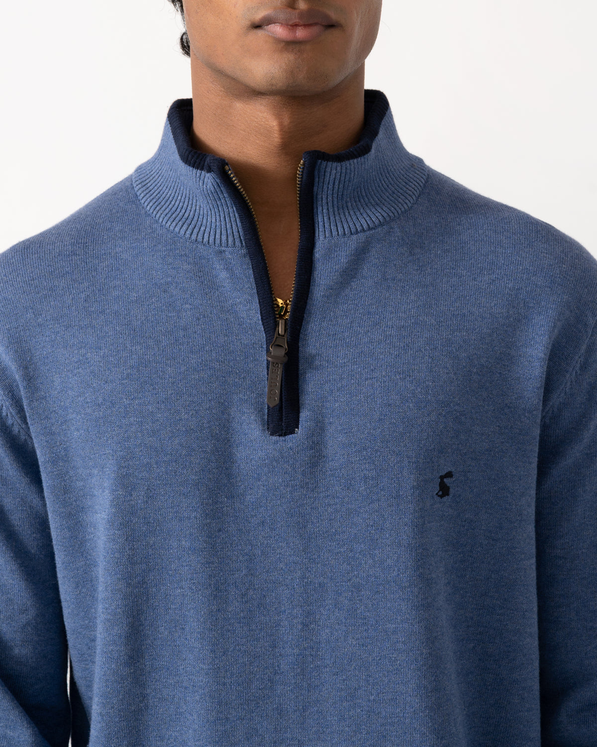 close up Studio photograph of a model wearing a Joules Hillside Mens 1/4 Zip Jumper in Blue