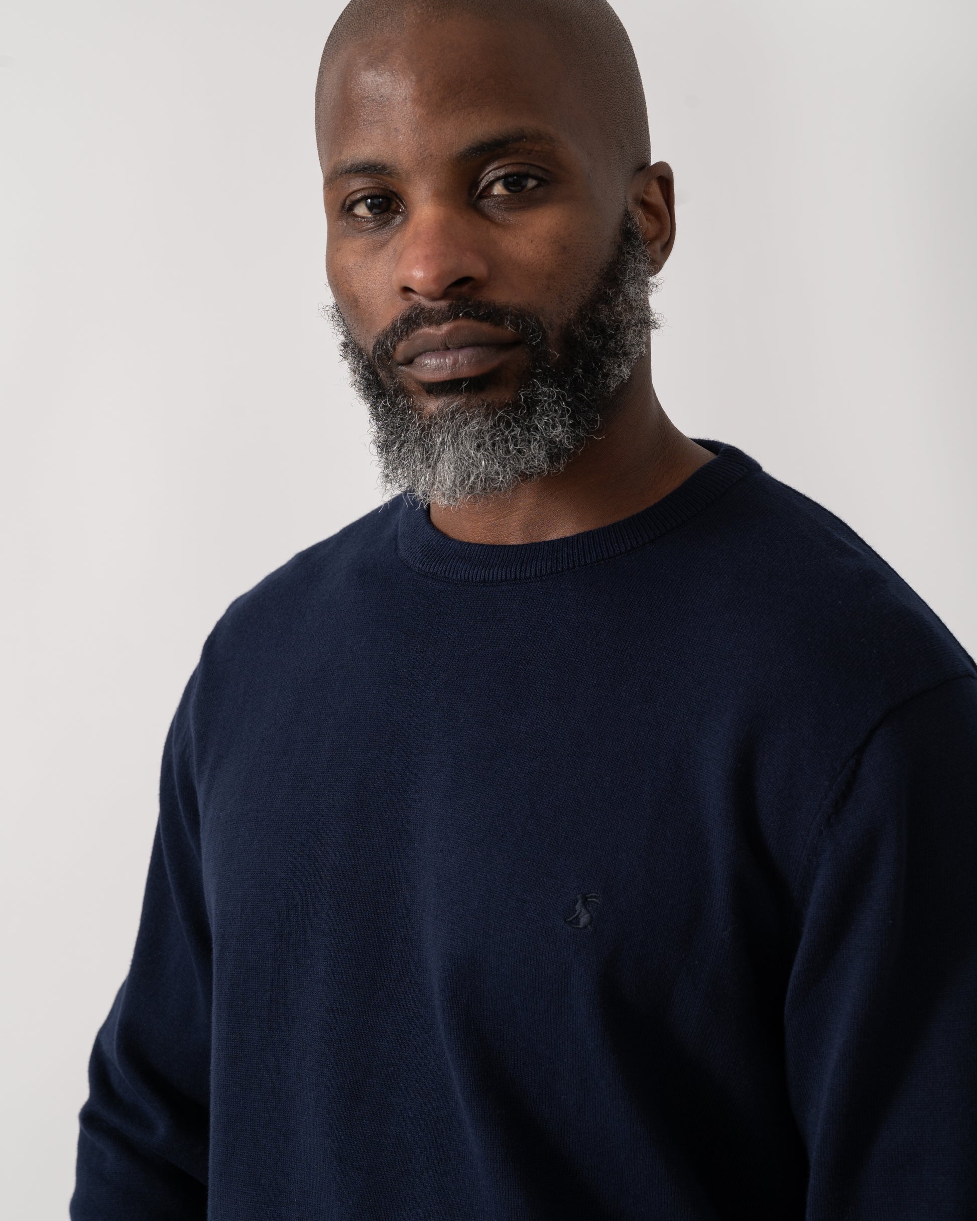 Detail shot of a Model wearing a Joules Hillside Mens Crew Neck Jumper in Navy Blue