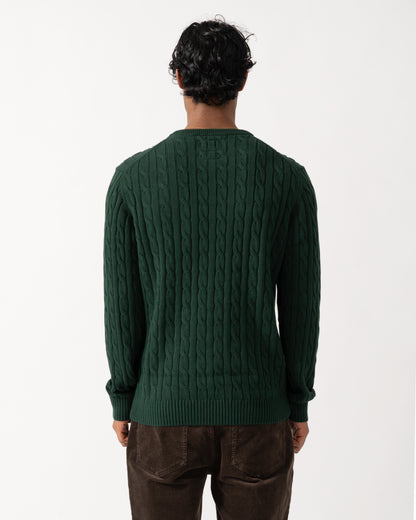 Studio photograph showing the back  of a model wearing a Joules Mens Cable Knit Crew Neck Jumper in Green