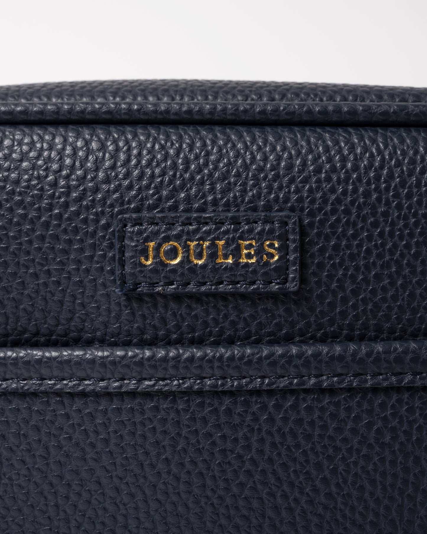 close up detail of a Joules Trent Womens Faux Leather Crossbody Bag in Navy
