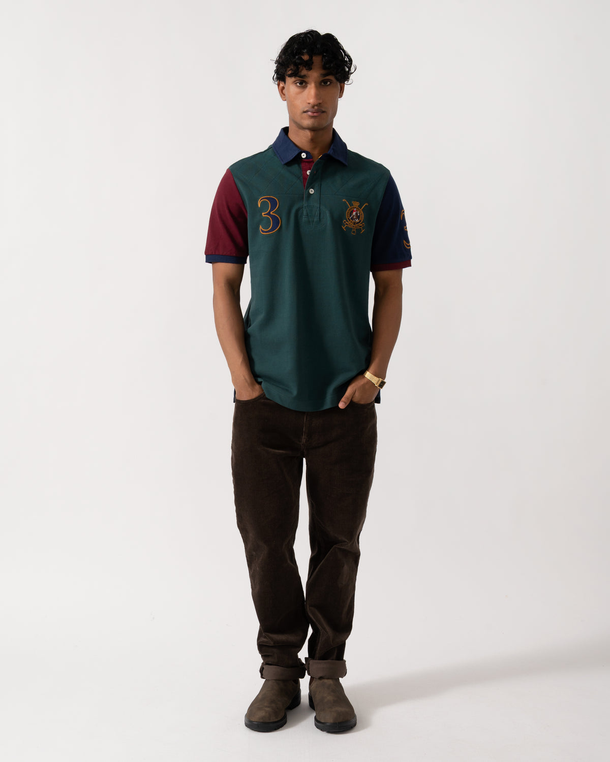 full length Studio photograph of a model wearing a Joules Woody Mens Embellished Polo Shirt in Green/Burgundy