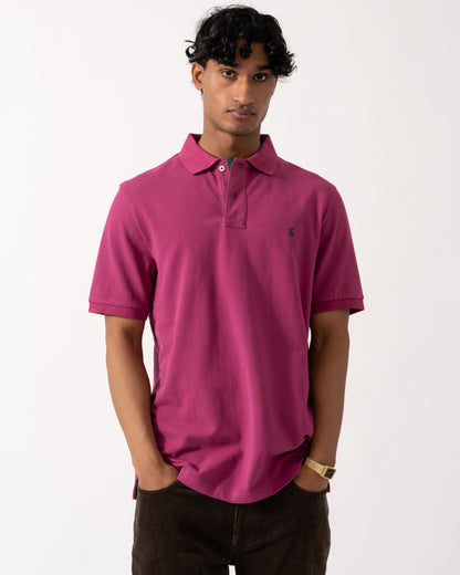 studio photograph showing a model wearing a Joules Woody Mens Polo Shirt in Berry Red