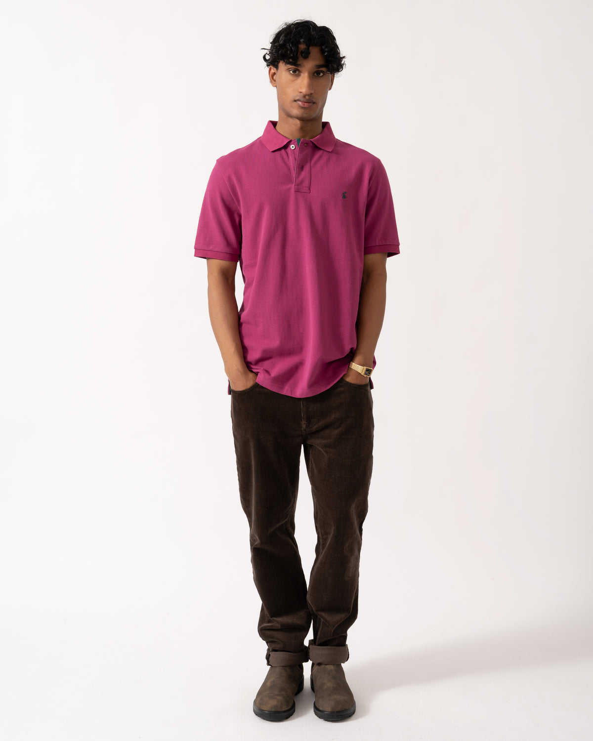full length studio photograph showing a model wearing a Joules Woody Mens Polo Shirt in Berry Red