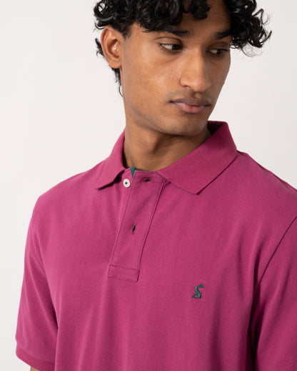 close up studio photograph showing a model wearing a Joules Woody Mens Polo Shirt in Berry Red