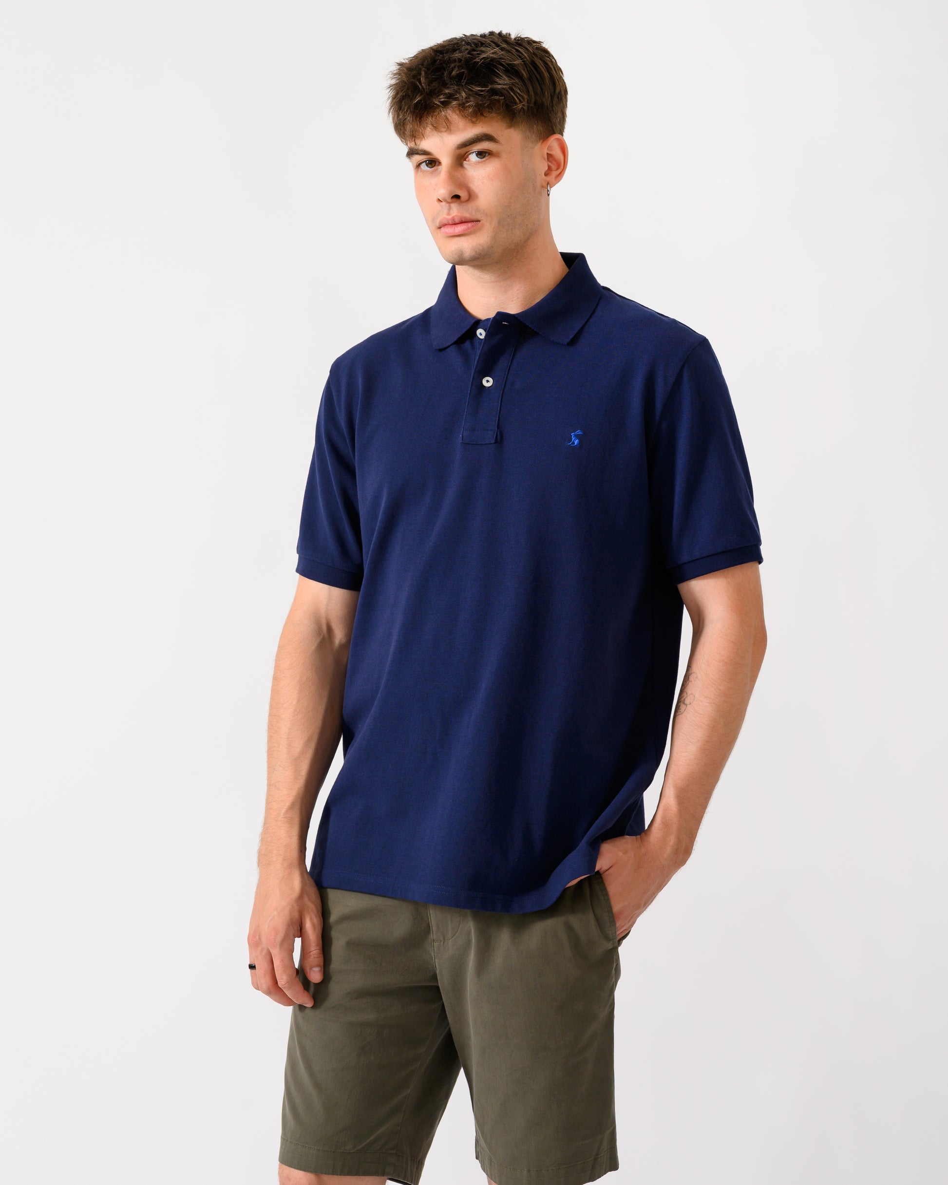 model wearing a Joules Woody Mens Polo Shirt in Dark Navy