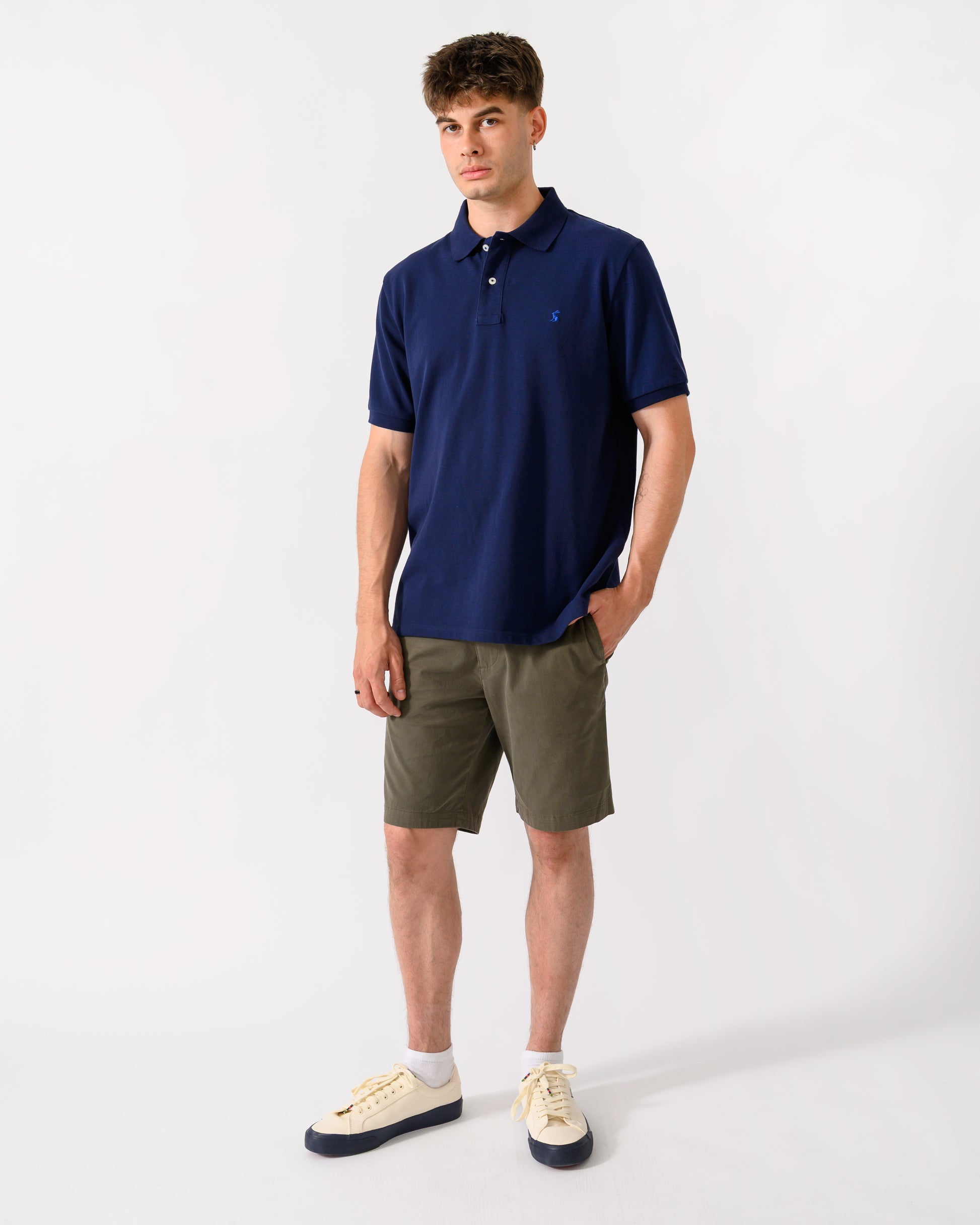 full length shot of a model wearing a Joules Woody Mens Polo Shirt in Dark Navy