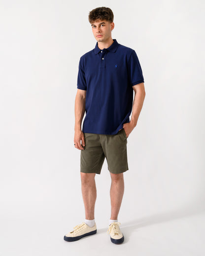 full length shot of a model wearing a Joules Woody Mens Polo Shirt in Dark Navy