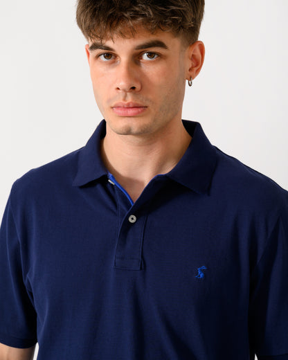 close up shot of a model wearing a Joules Woody Mens Polo Shirt in Dark Navy