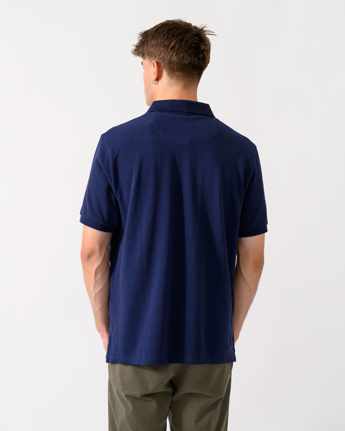 back shot of a model wearing a Joules Woody Mens Polo Shirt in Dark Navy