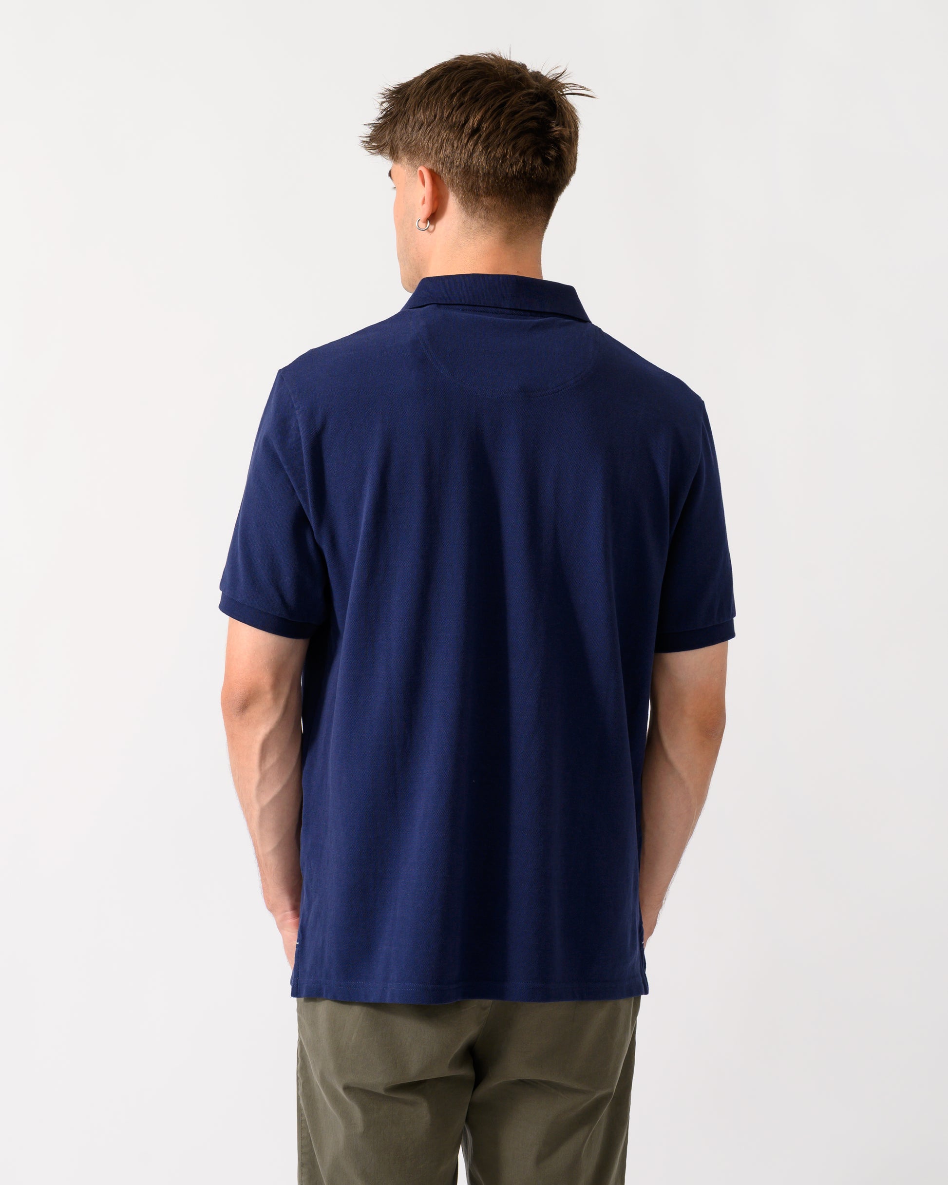 back shot of a model wearing a Joules Woody Mens Polo Shirt in Dark Navy