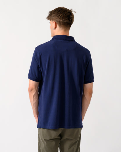 back shot of a model wearing a Joules Woody Mens Polo Shirt in Dark Navy