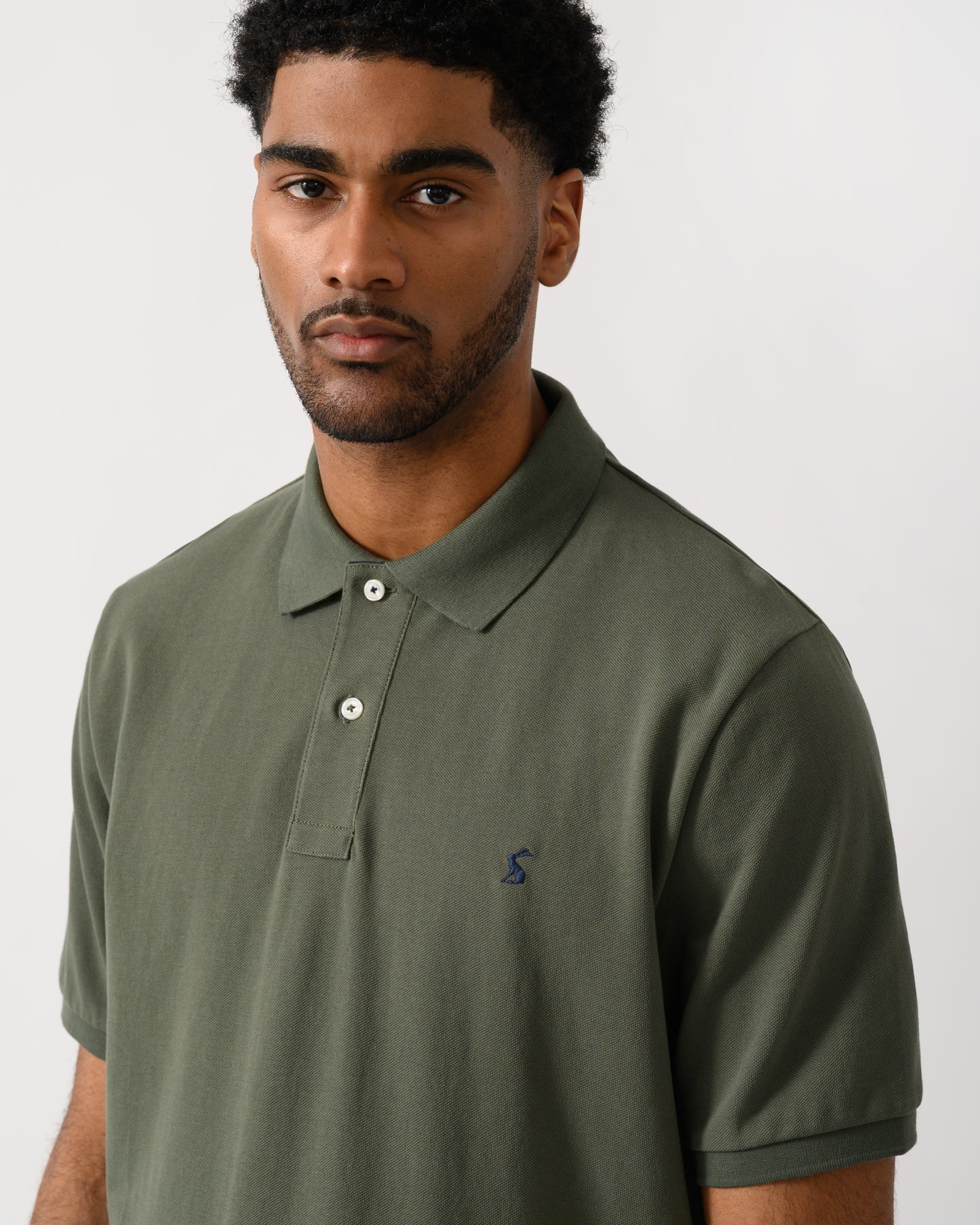 close up shot of a model Joules Woody Mens Polo Shirt in Khaki Green