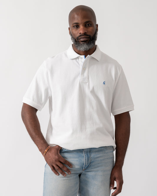 model wearing a Joules Woody Mens Polo Shirt in White
