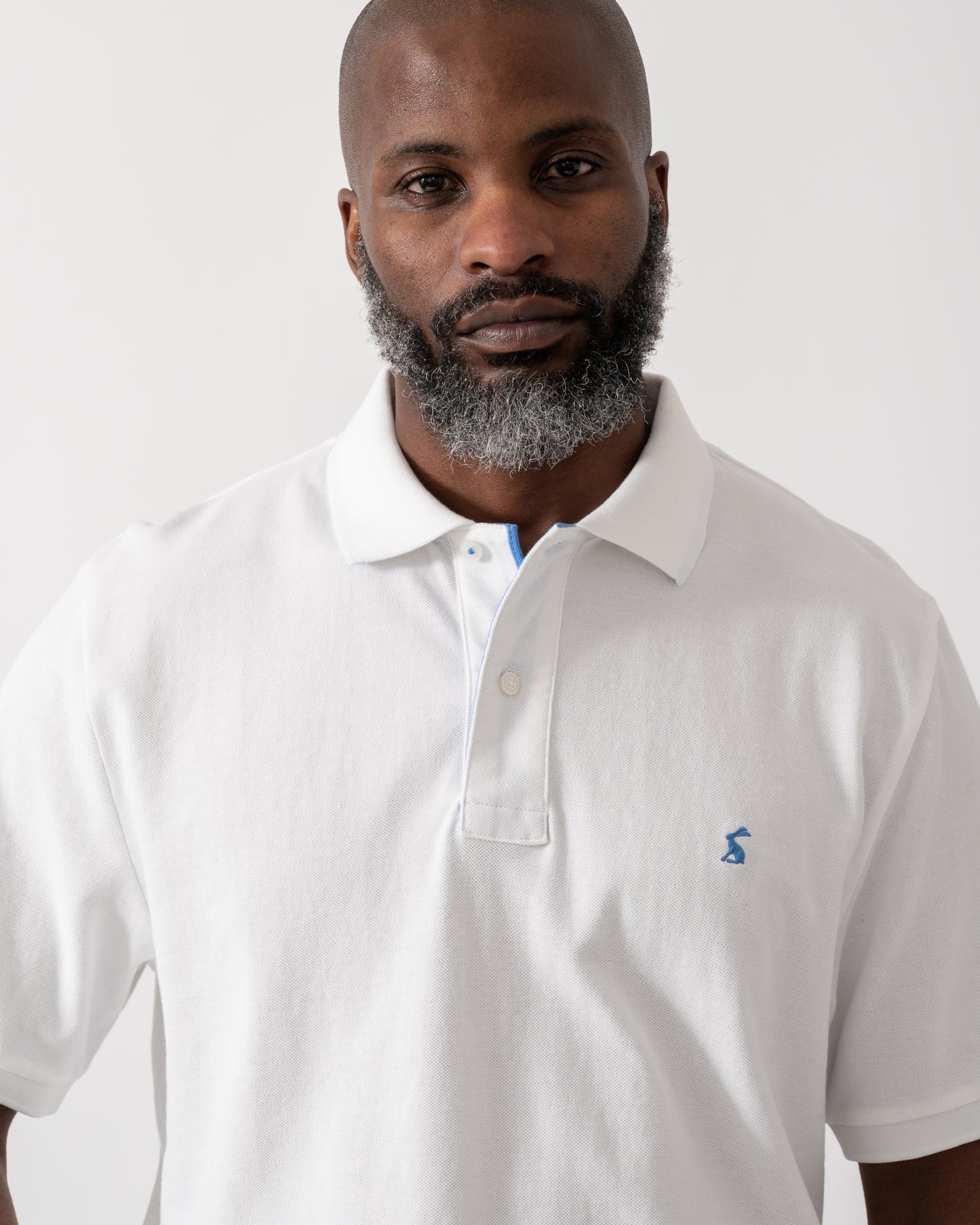close up shot of a model wearing a Joules Woody Mens Polo Shirt in White