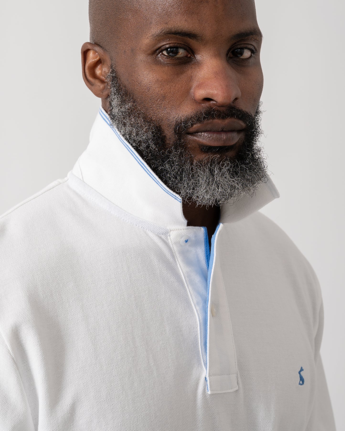 detail shot of a model wearing a Joules Woody Mens Polo Shirt in White