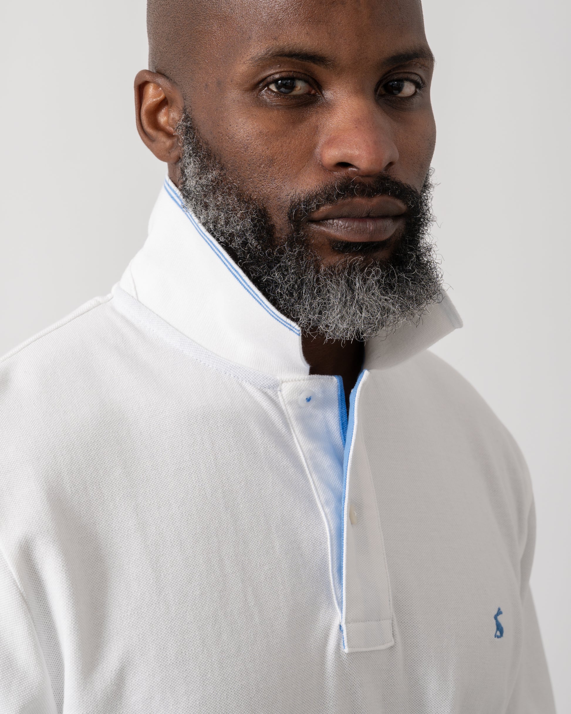 detail shot of a model wearing a Joules Woody Mens Polo Shirt in White