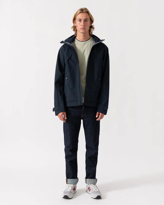 Man wearing the Joules Hadley Mens Waterproof Jacket - Navy unzipped