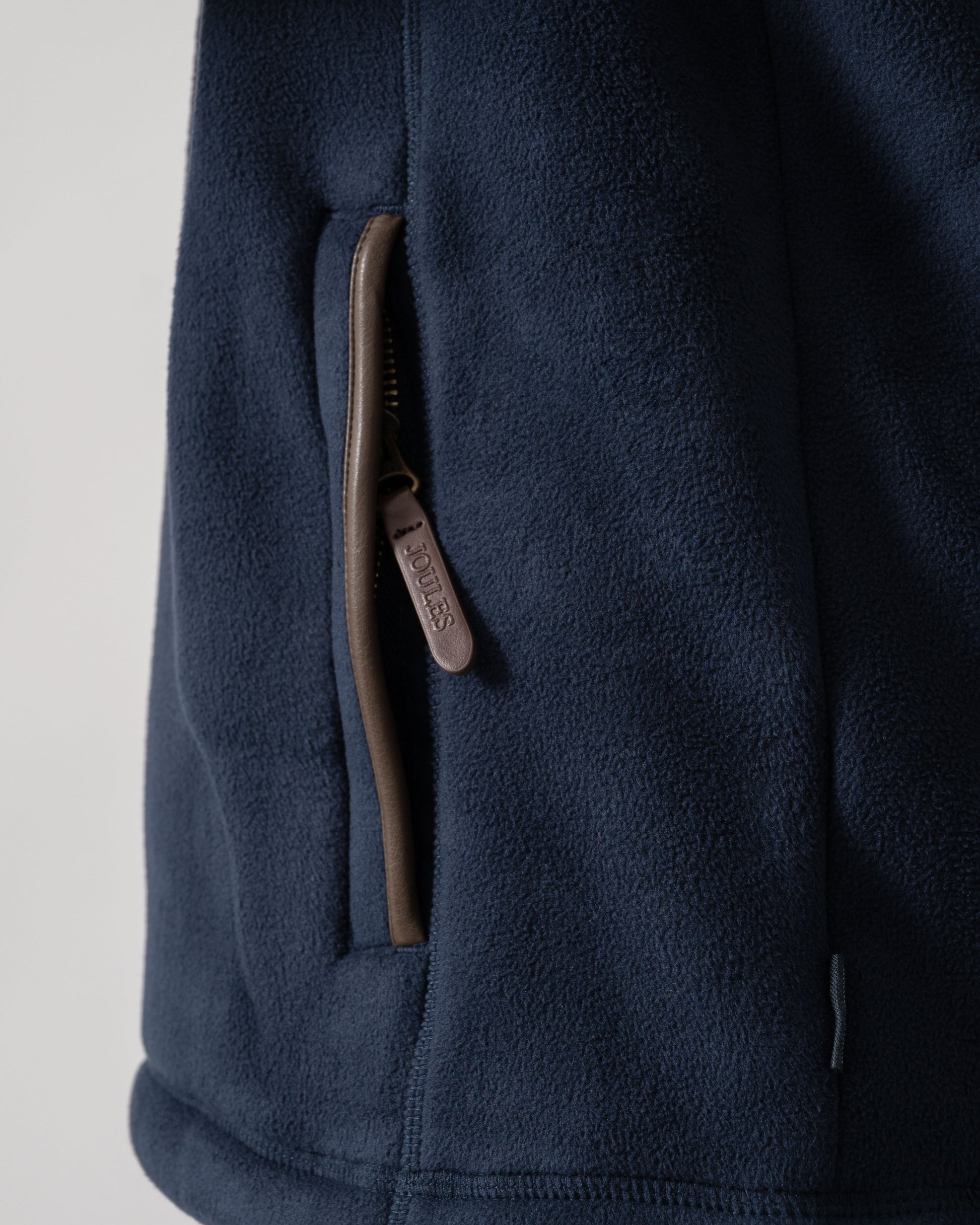 Model wearing Joules Mens Heritage 1/4 Zip Fleece in Navy - pocket detail