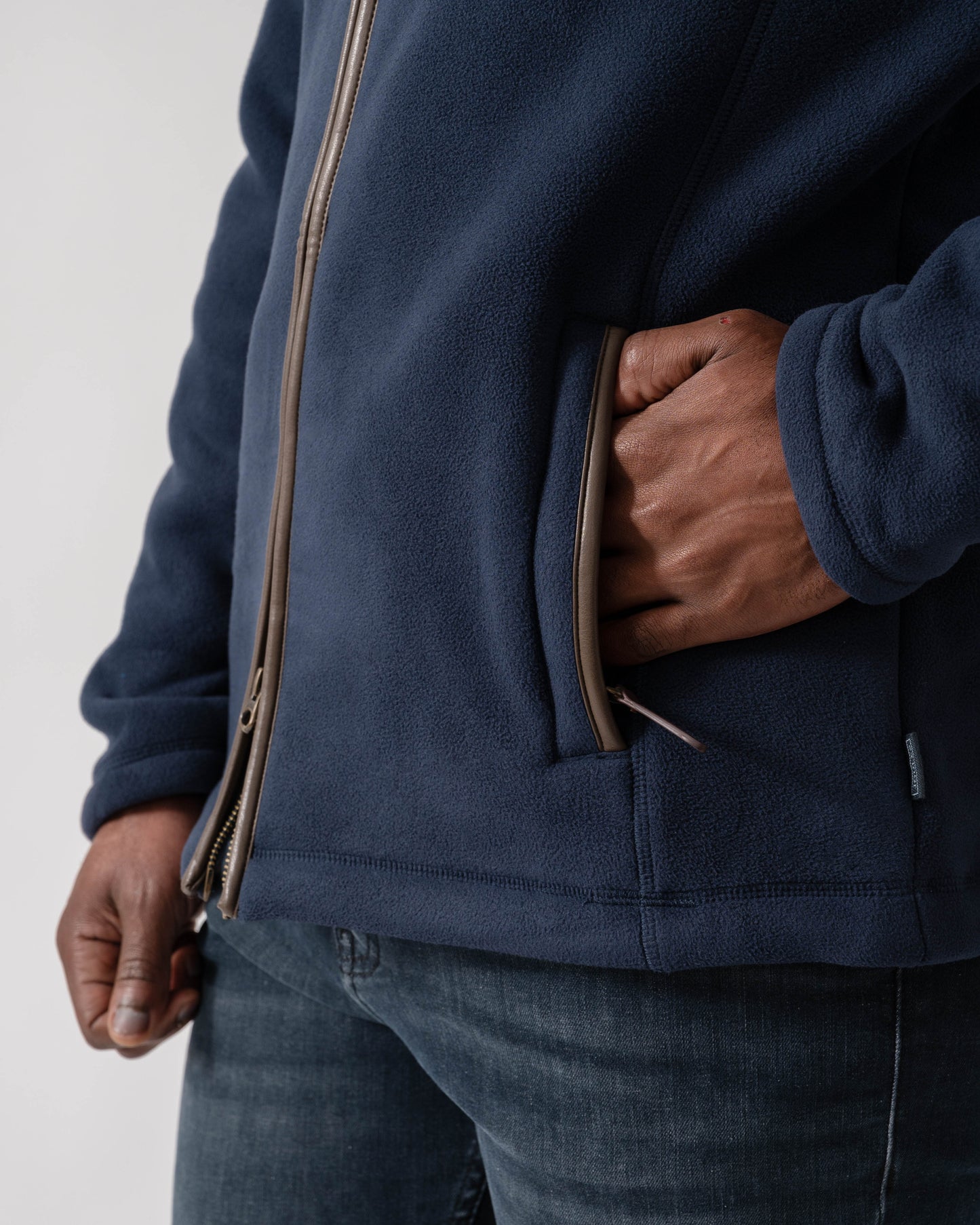 Model wearing Joules Mens Heritage Full Zip Fleece in Navy - Zip Pocket detail