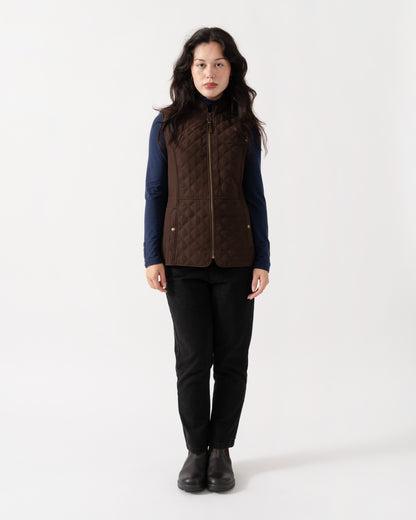 Model wearing Joules Minx Womens Diamond Quilt Gilet - Chocolate Brown