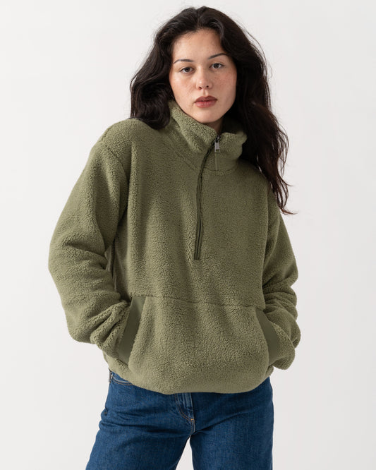 Woman with her hands in the pockets of the Joules Tilly Womens Cropped 1/4 Zip Fleece - Olive Green