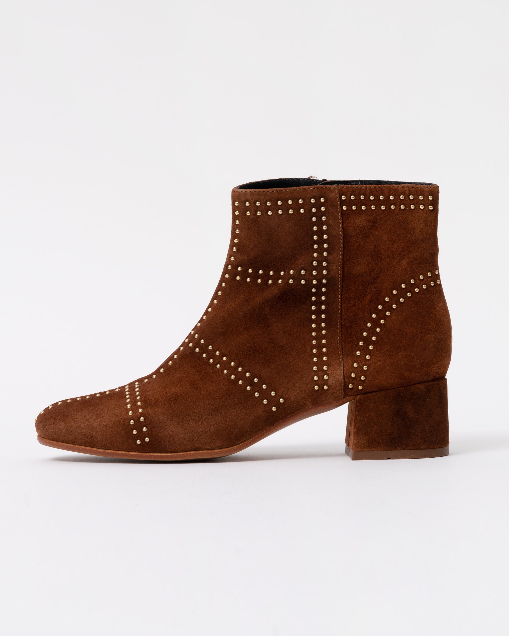 Brown suede ankle boot with studded details on a white background