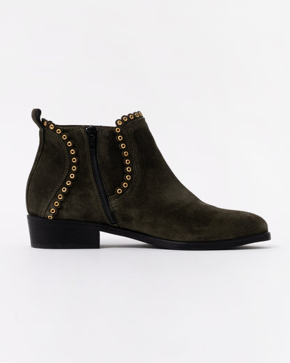 Dark brown suede ankle boot with gold studded details on a white background