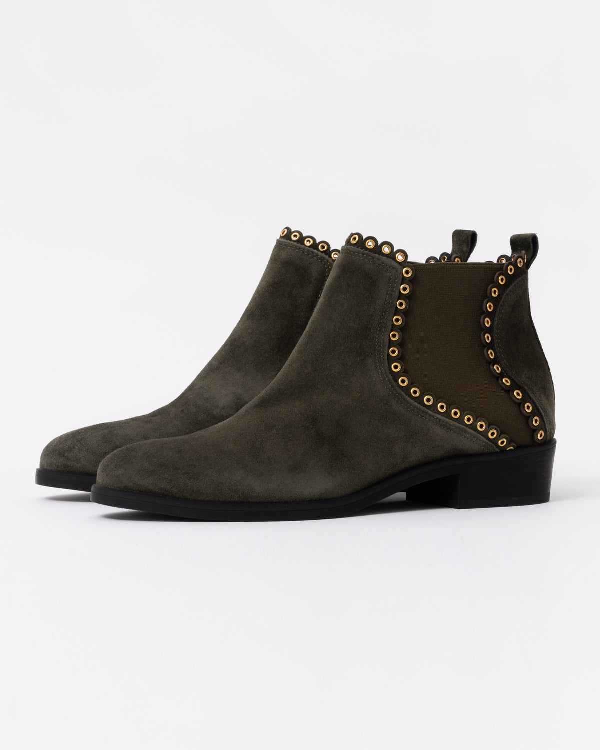 Pair of green suede ankle boots with studded details on a white background