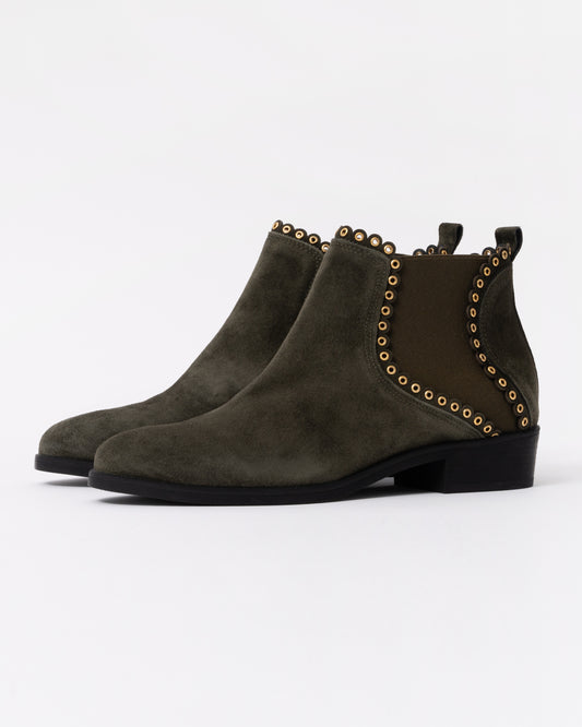 Pair of green suede ankle boots with studded details on a white background