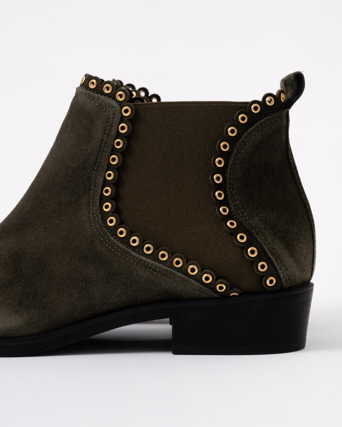 Dark brown ankle boot with gold studs on a white background