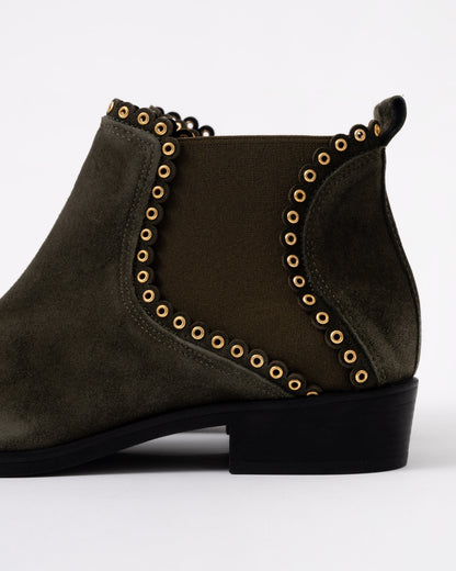 Dark brown ankle boot with gold studs on a white background