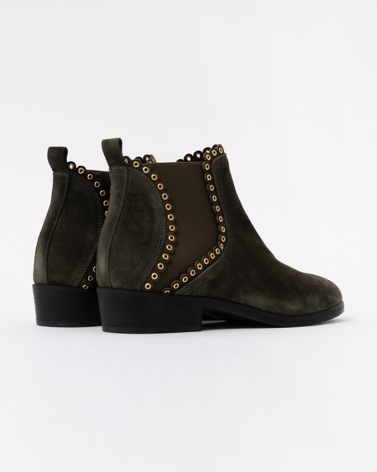Pair of dark green suede ankle boots with gold studs on a white background