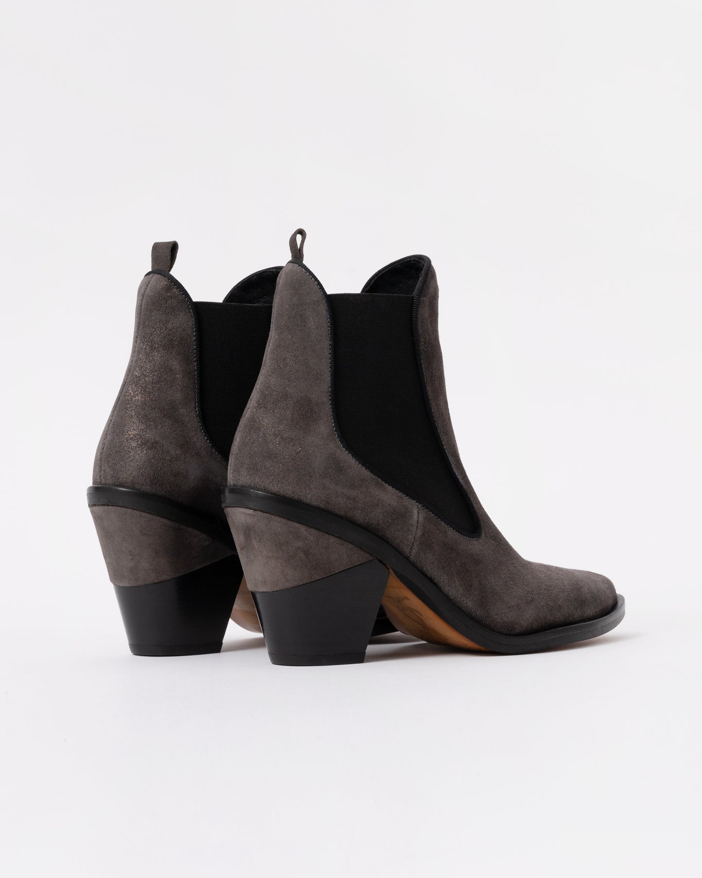 Pair of gray suede ankle boots with black soles on a white background