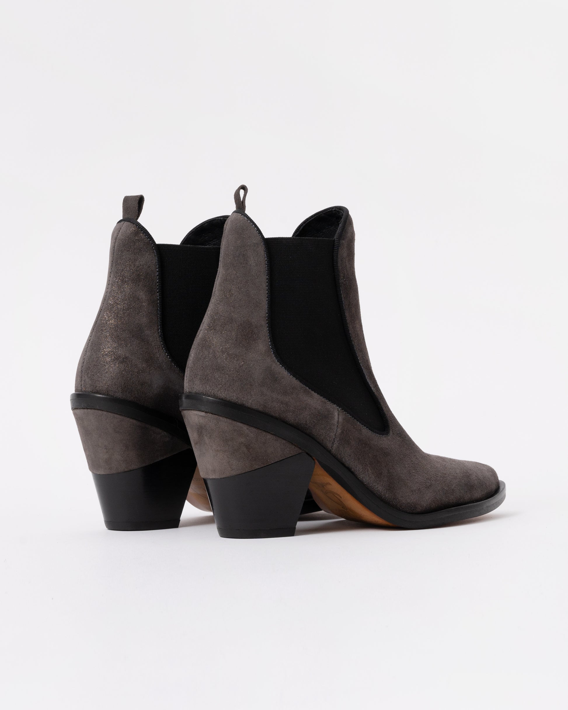 Pair of gray suede ankle boots with black soles on a white background