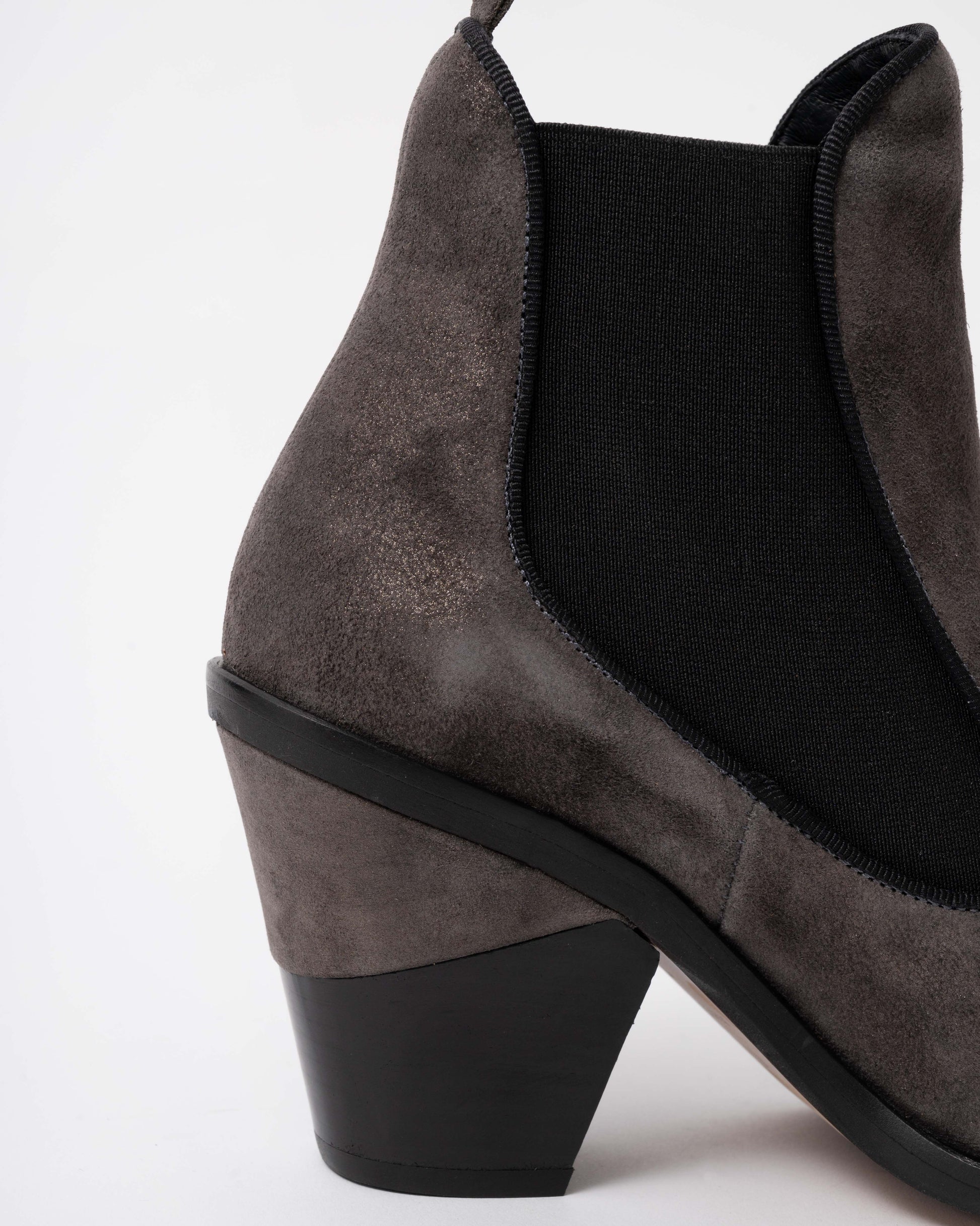 Gray suede ankle boot with a black sole on a white background