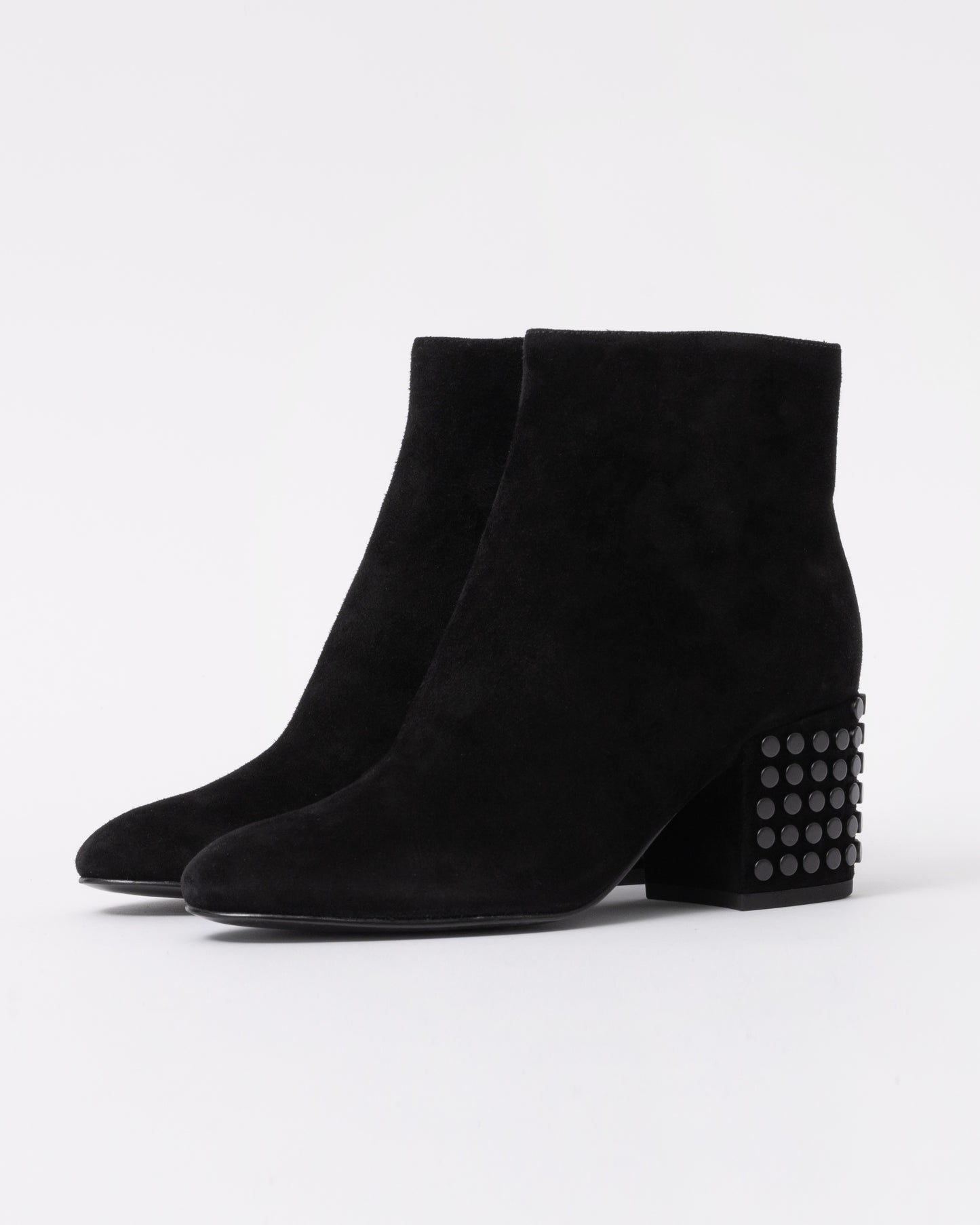 Black suede ankle boots with studded detail on a white background