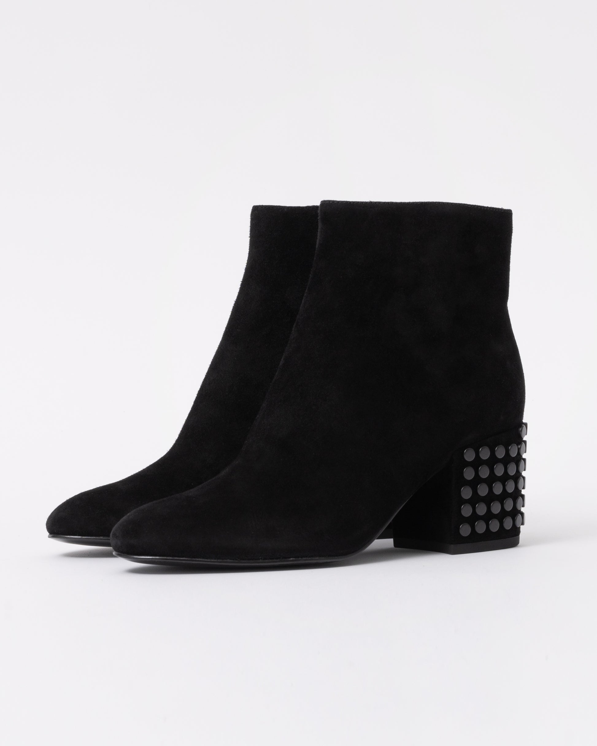 Black suede ankle boots with studded detail on a white background
