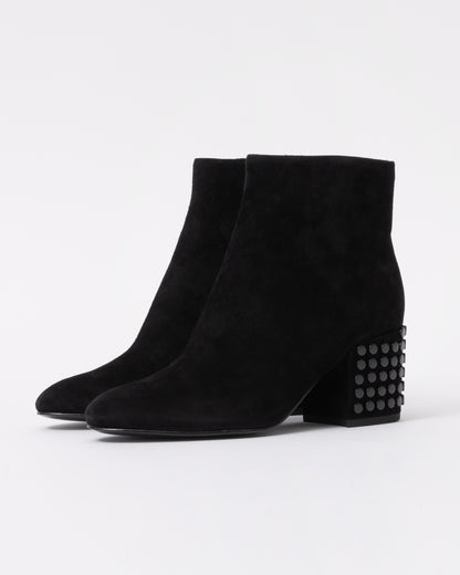 Black suede ankle boots with studded detail on a white background