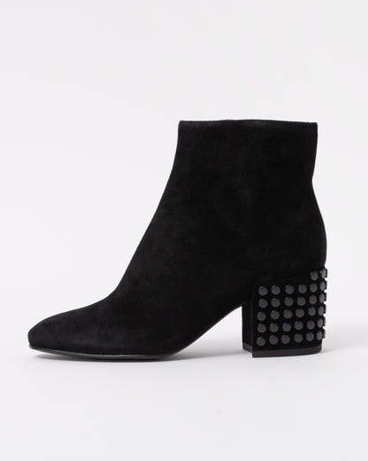 Black suede ankle boot with a textured block heel on a white background